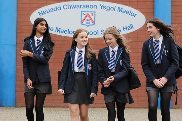 Female pupils walking outside sports hall