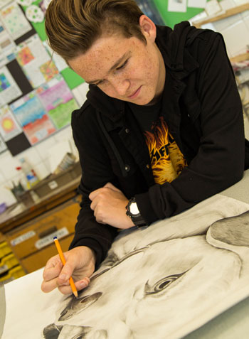 Male art pupil drawing animal portrait